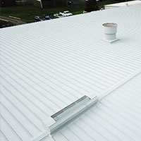 Reflective waterproof coating installed by CentiMark over a metal commercial roof