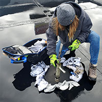 female roofer taking a core to see the condition