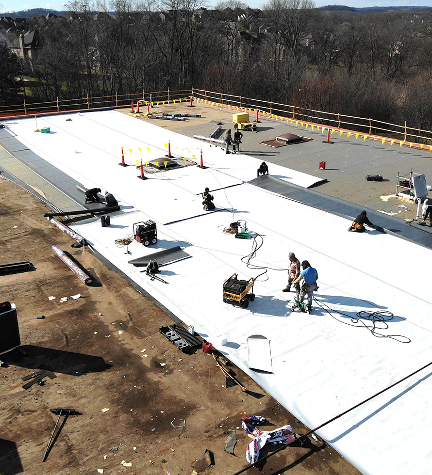 roofers installing a TPO roof