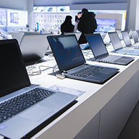 laptop computers lined up in a retail store