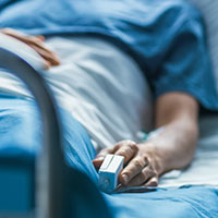 hospital patient in a patient room with a monitor on