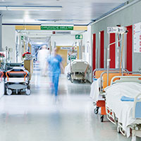 a nurse walking down a hospital corridor 
