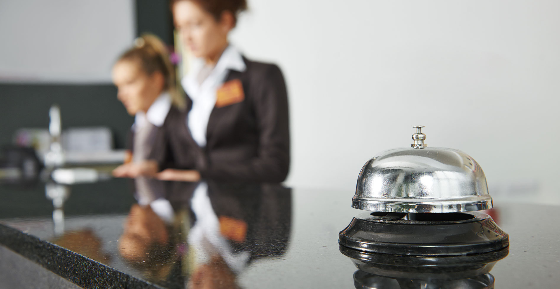 front desk of a hotel with a bell