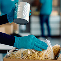 volunteer is sorting food for food bank