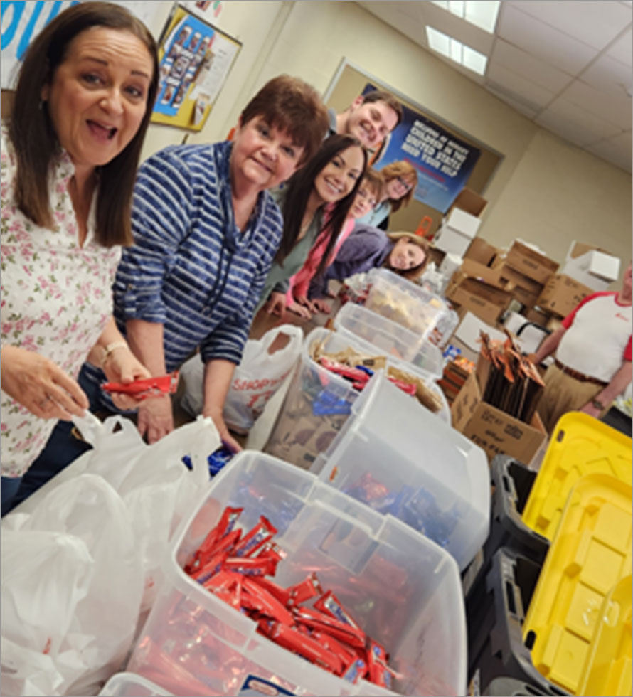 CentiMark volunteers packing gifts for charity