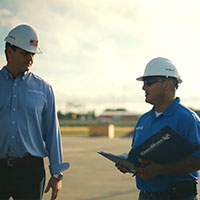 two senior roofers discussing a project