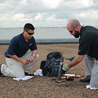 two techs taking roof core