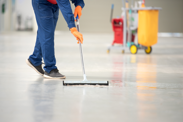 a factory worker cleaning the floor