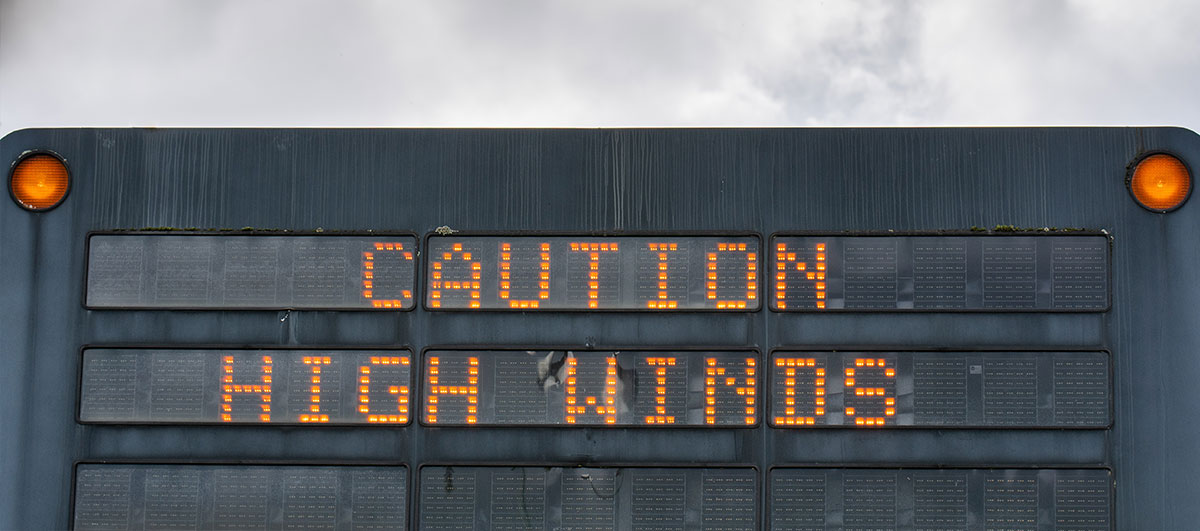 road warning sign about high winds