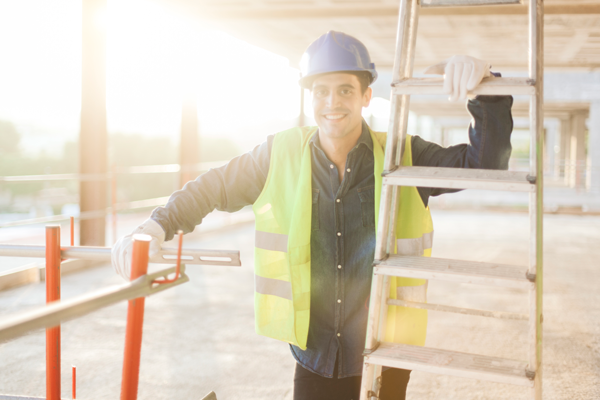 smiling construction worker with a ladder