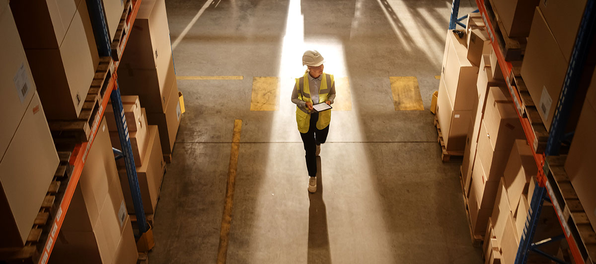 woman professional walking through a warehouse