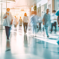 people walking through a hospital