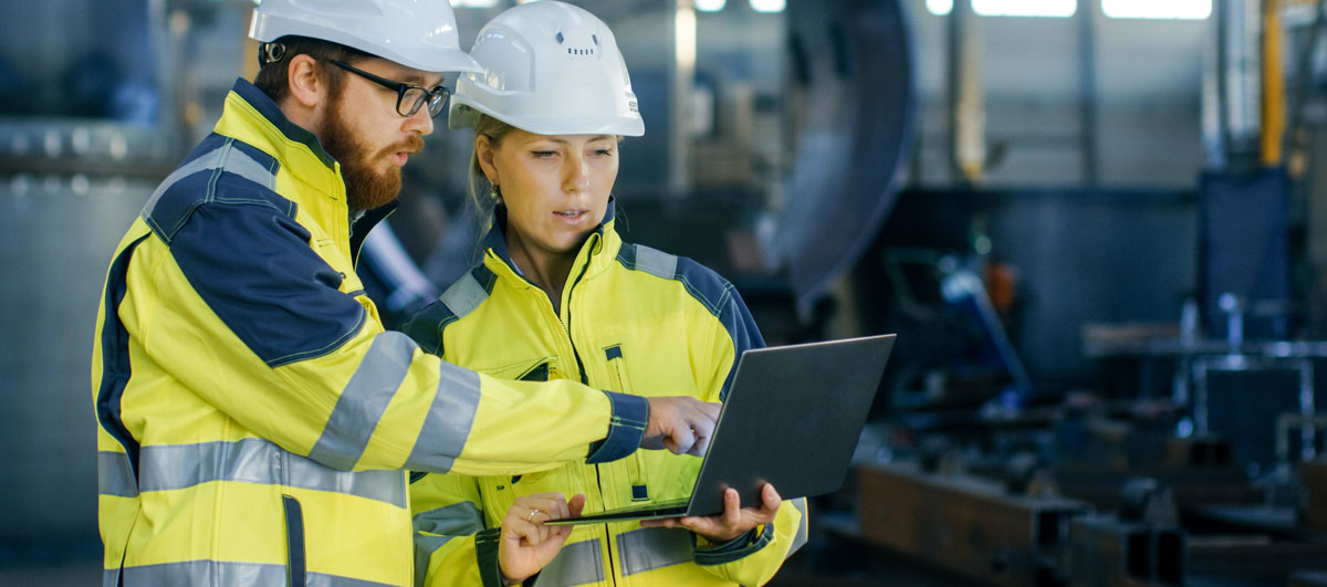 two engineers looking at a tablet