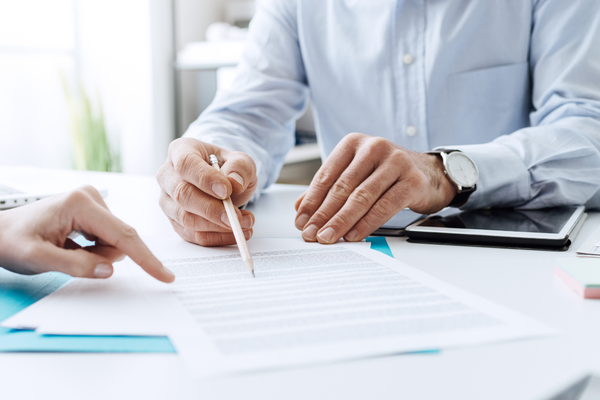 business people looking over documents and warranty information